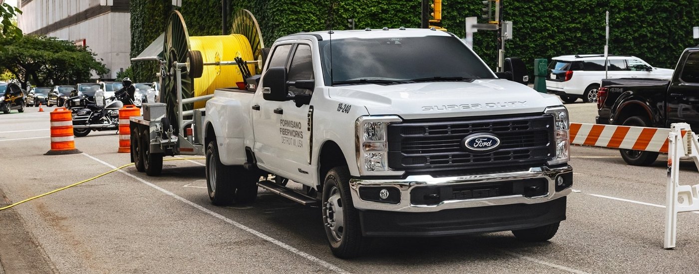 White 2025 Ford F-350 XL towing a large spool